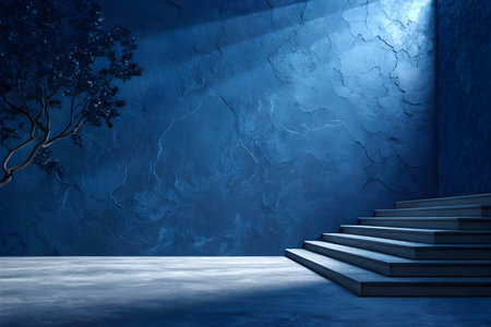 Dark blue wall pained interior wall design with a deep navy gradient with a soft lighting background. Conceptual image with stairs leading up to blue wall and spotlightsの写真素材