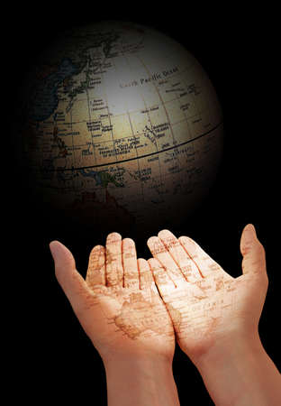 Hands and a globe in the dark backgroundの写真素材
