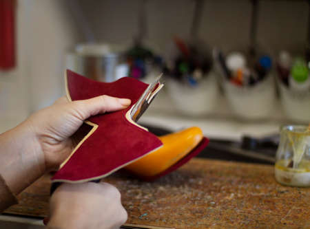 Hands of woman cutting fabric with a scissors