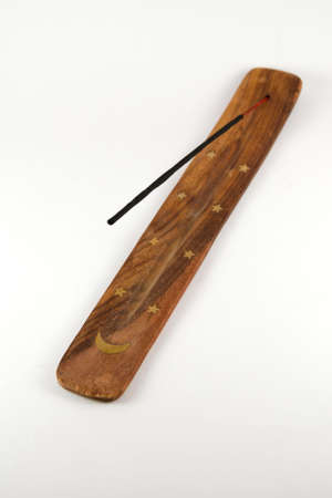Incense stick on wooden stand isolated on white backgroundの写真素材