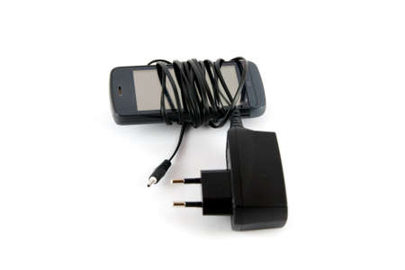 Phone and black charger isolated on white backgroundの写真素材