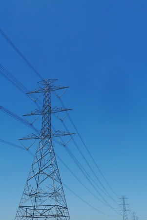 high voltage post with blue skyの写真素材