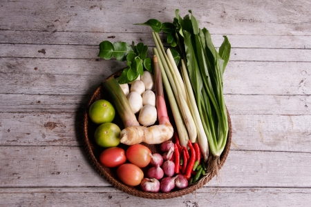 Ingredients for cooking tom yum soup in the threshing basket on wooden tableの写真素材