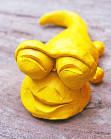 yellow Gecko baked clay dolls in the gardenの写真素材