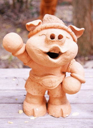 boxing pig baked clay dolls ornamental in the gardenの写真素材