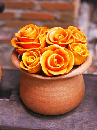 Vase of roses  baked clay ornamental in the gardenの写真素材