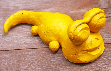 yellow Gecko baked clay dolls in the gardenの写真素材