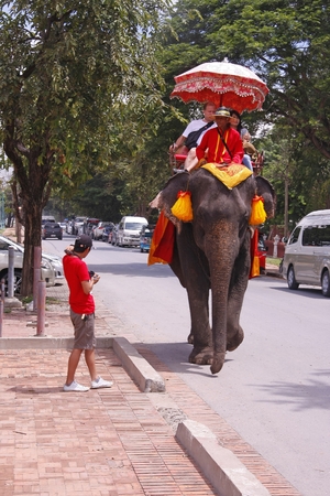 AYUTTHAYA, THAILAND - AUGUST 10   Tourist group rides on the backs of elephants visit the ancient city of Ayutthaya on August 10,2013 in Ayutthaya,Thailand のeditorial素材