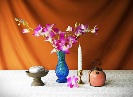 still life with vase,orchid,silver bowl,brass tray with pedestal,candle and Porcelain lamp  の写真素材