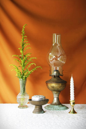 still life with vase,lotus,lamp,brass tray with pedestalsilver bowl and candle の写真素材