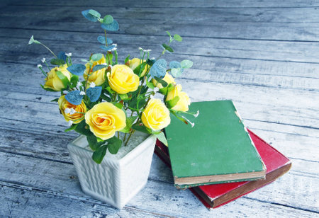 Still life with a beautiful classical bouquet of roses and old book in retro filter effectの写真素材