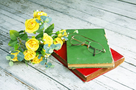 Still life with beautiful roses ,old book and glasses in retro effect の写真素材