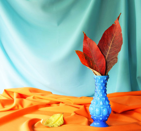 Still life with red leaves in a vintage vase  の写真素材