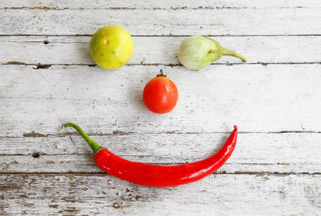 still life with vegetables on a wooden smiley faceの写真素材