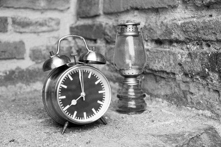 still life with vintage retro alarm clock on old brick background (black and white concept )の写真素材