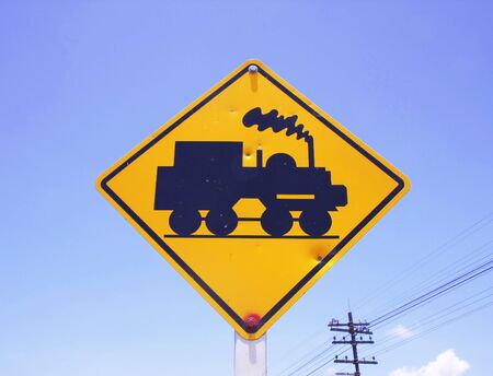 Train crossing Sign with blue skyの写真素材