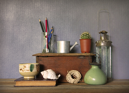 still life with tea cup and vintage objects on wooden table.の写真素材