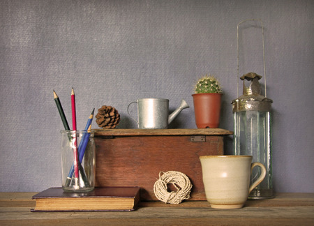 still life with tea cup and vintage objects on wooden table.の写真素材