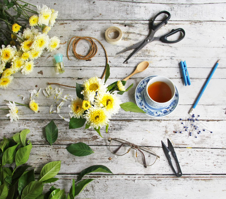 still life with tea cup and the contents of a workspace composed. Different objects on wooden table.の写真素材