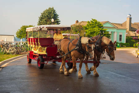 Mackinaw Island, MI - July 14, 2021: Horse drawn carriage on Mackinac Island, MI on July 14, 2021.のeditorial素材