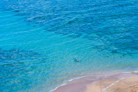 Tourist snorkeling in blue tropic waters of Hanauma Bay