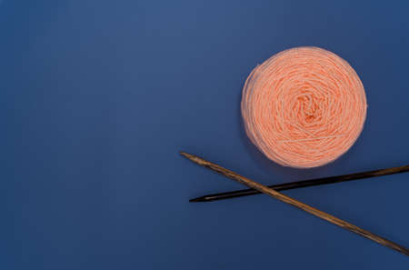 Calming coral yarn skein with colorful blue background