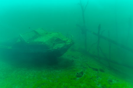 Gloomy underwater wreck of recreational speed boat