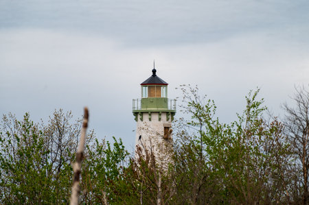 The Tawas Point Lighthouse fresno lens under repair as it towers over the wildernessの写真素材