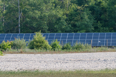 Yankee Springs, MI - July 22, 2023: Photovoltaic modules solar panels installed in a rural fenced in...