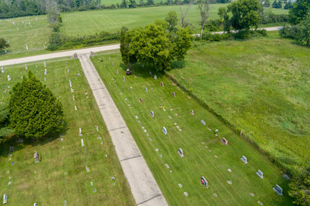 Aerial view flying over a green cemetery graveyard