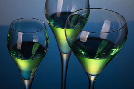 three glasses with cocktails on a blue backgroundの写真素材