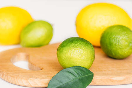 lemon, lime and mint on a wooden board on a white backgroundの写真素材