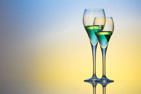 two glasses with cocktails on a colorful backgroundの写真素材