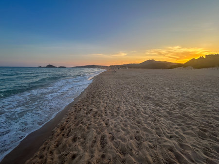 Beautiful sunrise on the beach in sardinia italyの写真素材