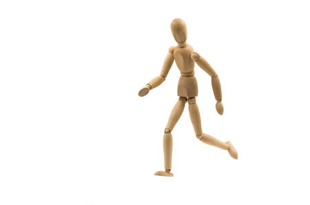 running wooden man puppet on white background