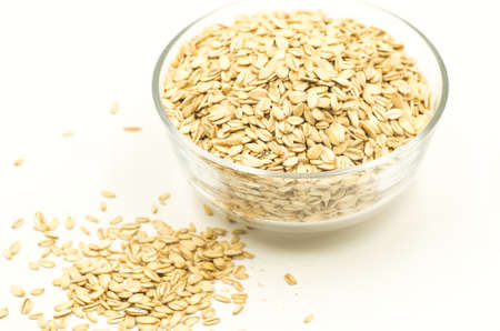 oatmeat porridge cereal flakes in a crystal bowl on white backgroundの写真素材