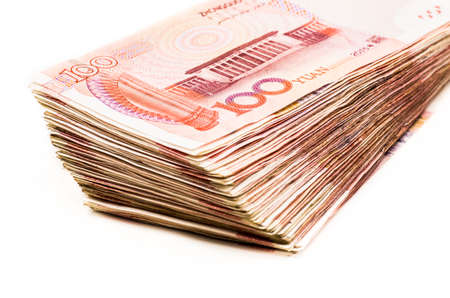 pile of chinese yuan bank notes on white backgroundの写真素材