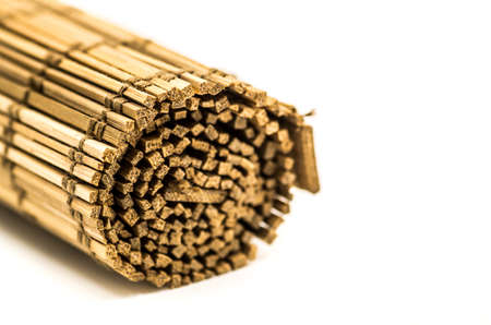 wooden table mat in a roll on white backgroundの写真素材