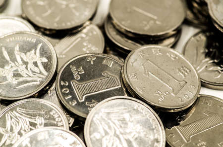 metal chinese coins scatter on the white backgroundの写真素材