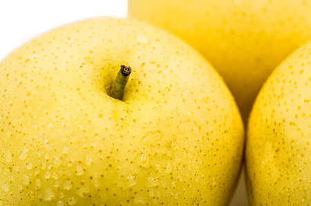 wet yellow pear macro isolated on white backgroundの写真素材