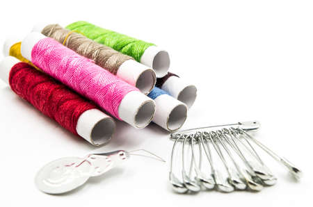 sewing tools and pins on the white backgroundの写真素材