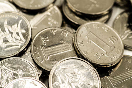 metal chinese coins scatter on the white backgroundの写真素材