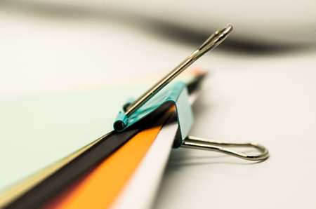 colorful paper clips on the white backgroundの写真素材