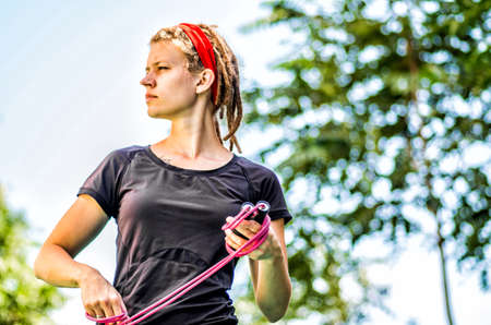 woman with dreadlocks working with a jump rope