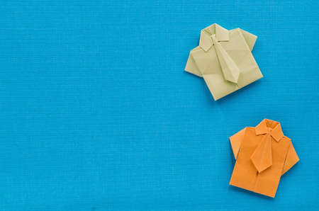 origami paper businessman shirts with ties on textures blue backgroundの写真素材
