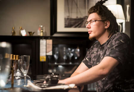 european man with afro hairstyle is choosing a restaurant. man is having a dinner