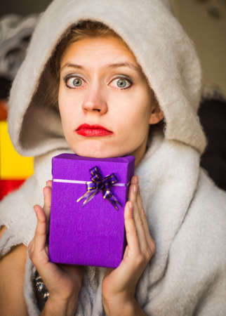 Surprised woman with a giftの写真素材