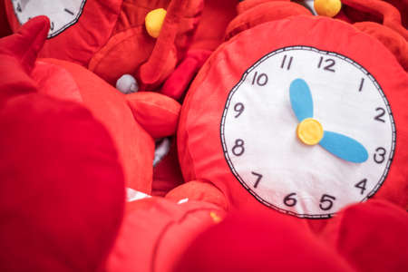 red soft toy clock in the box in the toy storeの写真素材