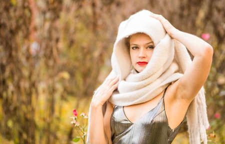 Beautiful Aeuropean woman portrait outdoors. Portrait of beauty model with bright make-up in a headscarfの写真素材
