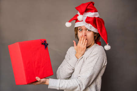 surprised young caucasian woman with tree christmas hatsの写真素材